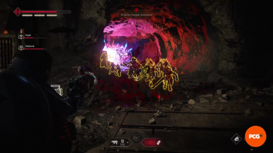 Space Marine 2 builds: A Tactical player firing a pistol at scanned enemies in a cave tunnel.